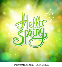 Hello Spring fresh green greeting card vector design with flowing text on an abstract glowing green background with sparkling bokeh