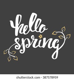 Hello Spring. Hand lettering, calligraphy inscription with spring leaves.