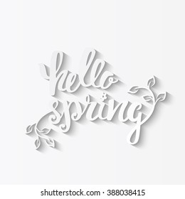 Hello Spring. Hand lettering, calligraphy inscription with spring leaves.