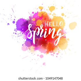 Hello Spring hand lettering phrase on watercolor imitation color splash. Modern calligraphy inspirational quote. Vector illustration.