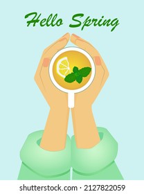Hello Spring hands holding a mug with tea lemon mint leaves 