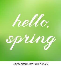 Hello, spring. Handwritten illustration, hand made brush lettering. Cute handwriting on a cheerful blurred background, can be used for greeting cards, scrapbooks, photo overlays and more.