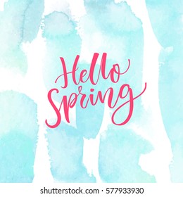 Hello Spring. Modern calligraphy text at blue watercolor texture. Inspirational saying. Spring season greetings.