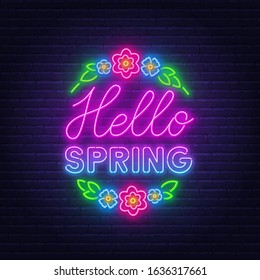 Hello Spring neon lettering on brick wall background.
