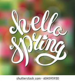 Hello Spring. Vector illustration EPS10. Handwriting lettering.Blurred background,brashlettering words. Calligraphy template. Spring season type.
