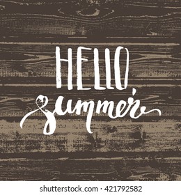 Hello summer hand lettering on wooden background.