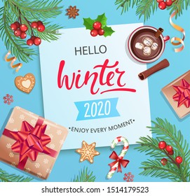 Hello winter 2020 card or banner with hand drawn lettering on blue background with christmas gifts, candies, coffee with cinnamon and marshmallow, cookie, place for text. Top view.Vector Illustration.