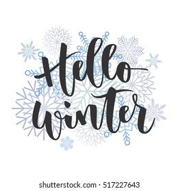 Hello winter black hand written inscription with blue snowflakes on white background