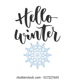 Hello winter black hand written inscription with blue snowflake on white background