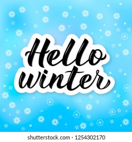 Hello Winter calligraphy lettering. Bright blue background with flying snowflakes. Winter party decorations. Holiday mood vector illustration. Easy to edit template for banner, greeting card etc. 