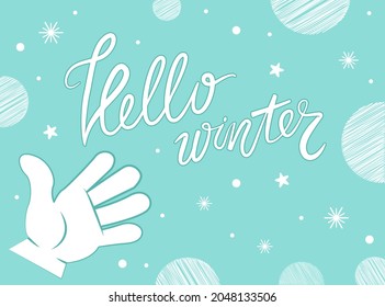 Hello winter concept. Handwritten brush lettering. Calligraphic text with white stars snowflakes and balls. Blurred winter banner with christmas subjects and typographic label on blue background