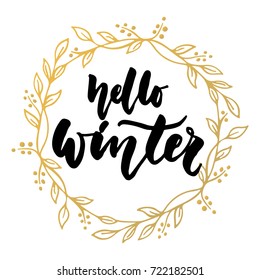 Hello, winter - hand drawn lettering quote with golden wreath isolated on the white background. Fun brush ink inscription for greeting card or t-shirt print, poster design