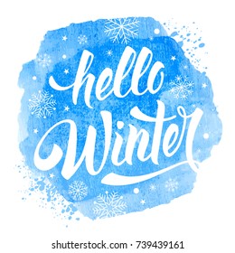 Hello Winter handwritten calligraphy inscription on blue watercolor background with snowflakes. Hand drawn winter inspiration phrase. Vector illustration.