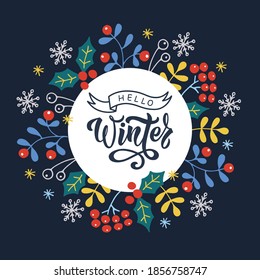 Hello winter handwritten text on round white label. Vector illustration of colorful winter objects (holly, berries, leaves, snowflakes) on dark blue background.Design for poster, card, print.