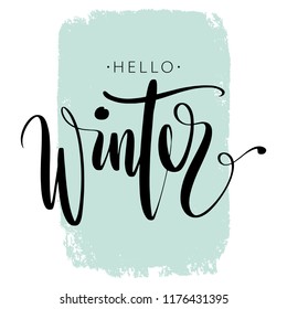 Hello winter phrase by hand on colorful background stroke. Hand drawn creative calligraphy and brush pen lettering, design for holiday greeting cards, banners and invitations.