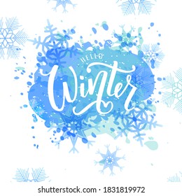 Hello Winter text on textured watercolor blots effect background. Hand lettering typography. Concept Winter advertising