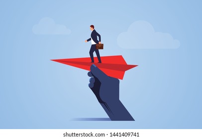 Help take off, huge hand holding paper plane and take off with businessman