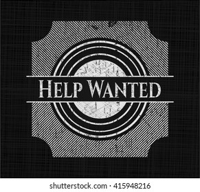 Help Wanted chalk emblem written on a blackboard