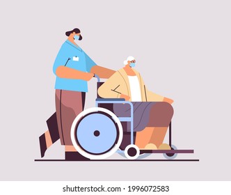 helper taking care of senior disabled patient nurse pushing wheelchair care service concept