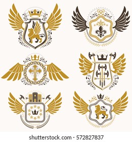 Heraldic emblems with wings isolated on white backdrop. Collection of vector symbols in vintage style created using heraldry elements like crowns, towers, crosses and armory.