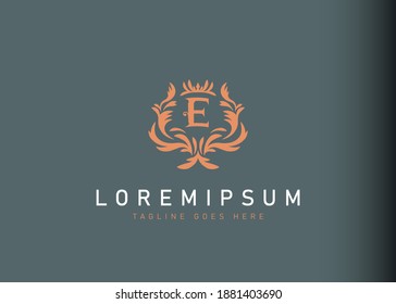 Heraldic initial letter E logo design. Vector illustration of elegant floral initial letter E icon design. Modern logo design with emblem style.