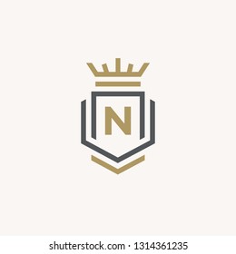 Heraldic Letter N monogram. Elegant retro minimal logo design. Letter N + Crown + Book + Shield.