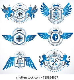 Heraldic vector signs decorated with vintage elements, monarch crowns, religious crosses, armory and animals. Set of classy symbolic graphic insignias with bird wings.