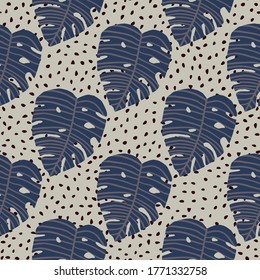 Herbal seamless pattern with blue monstera leaves. Pastel light background with dark dots. Vector illustration. Perfect design for wallpaper, wrapping paper, kids clothes, textile, fabric.