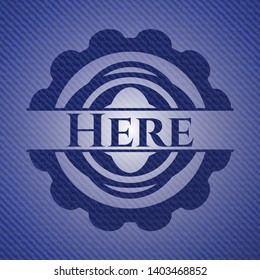 Here badge with jean texture. Vector Illustration. Detailed.