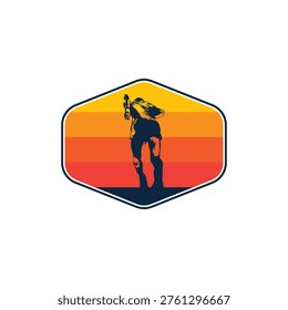 Hexagonal emblem features a silhouette of a cowboy holding a lasso against a gradient background of yellow to red horizontal stripes. The cowboy appears to be standing or walking, creating a vintage or retro aesthetic. The design is encased in a thin blue outline, highlighting the contrast between the dark silhouette and the vibrant background. This style is often used for logos or badges in contexts related to western or outdoor themes.