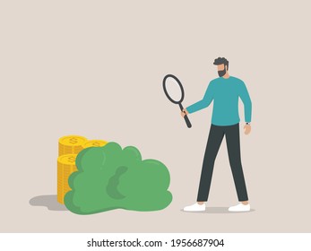 hidden cost concept, businessman looking for coins hidden using a magnifier