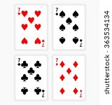 High Angle View of Four Playing Cards Spread Out on White Background Showing Sevens from Each Suit - Hearts, Clubs, Spades and Diamonds