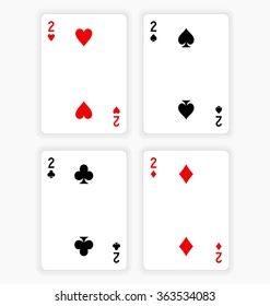 High Angle View of Four Playing Cards Spread Out on White Background Showing Twos from Each Suit - Hearts, Clubs, Spades and Diamonds