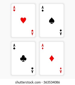 High Angle View of Four Playing Cards Spread Out on White Background Showing Aces from Each Suit - Hearts, Clubs, Spades and Diamonds