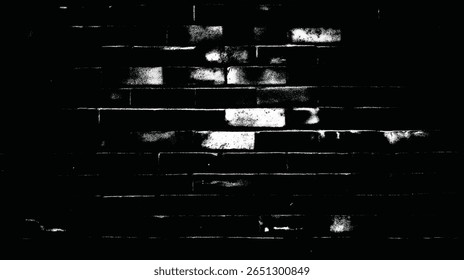 a high contrast monochrome image showing a brick wall with texture and signs of wear and tear throughout