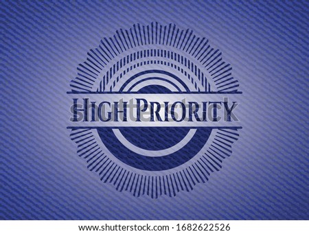 High Priority emblem with jean high quality background. Vector Illustration. Detailed.