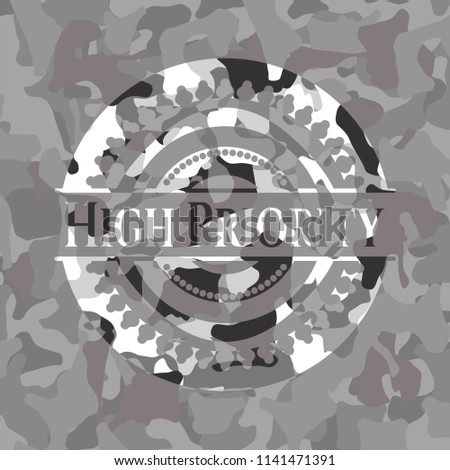 High Priority written on a grey camouflage texture