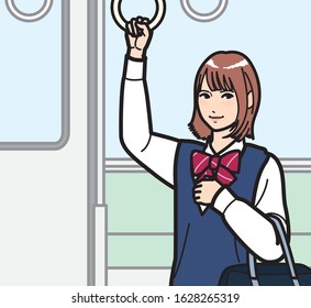 A high school girl holding on to the strap on a train.