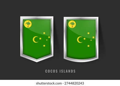 High-quality 3D vector illustration of Cocos Islands flag badges. Metallic silver shields featuring the palm tree, crescent moon, and Southern Cross on a green field for Australian territory