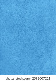 High-resolution blue microfiber fabric texture background. Perfect for digital designs, branding, presentations, websites, and textile-related projects. Soft, plush, and evenly textured surface.