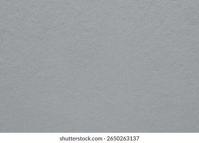Image haute résolution d'un mur en plâtre uni avec une texture rugueuse subtile. La surface présente un motif naturel minimal idéal pour les maquettes architecturales, les arrière-plans de design ou la texture sur
