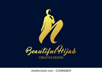 Hijab boutique logo design with the concept of a veiled woman in silhouette combined with the letter n. Hijab fashion logo vector illustration.