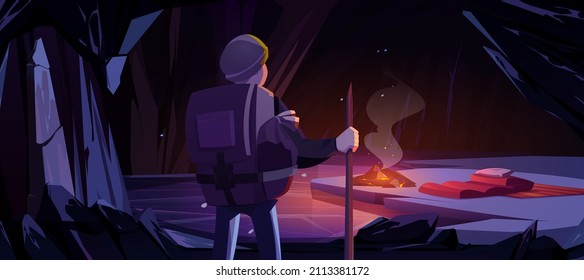 Hiker in mountain ice cave with campfire and sleeping bag, tourist halt, overnight place with frozen pond. Adventure game, book scene with traveler character in dark cavern Cartoon vector illustration