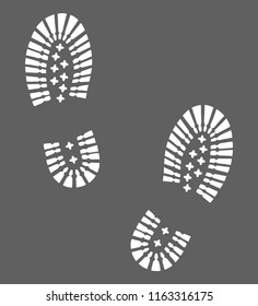 Hiking boots footprints graphic icon. Footprints shoe sign isolated on gray background. Vector illustration