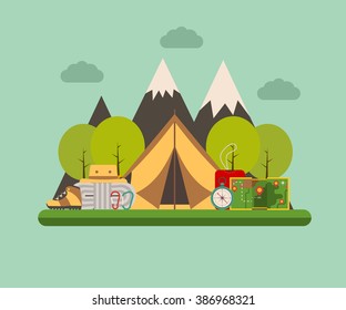 Hiking and climbing concept background. Tramping elements on forest campground landscape. Camping tent, sleeping bag, compass, map, climbing rope, carabiners, tourist hat and shoes. Mountain camping.