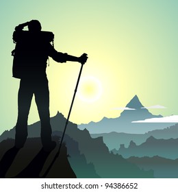 Hiking man with rucksack in mountain in the morning