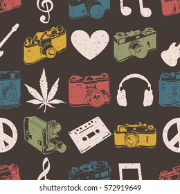 Hippie seamless pattern with marijuana leaves, headphones, old camera, heart, music note, cassette records, peace symbol on dark background. Wrapping paper. Vector illustration