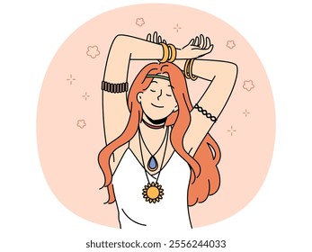 Hippie woman with amulet and bracelets on hands closes eyes, feeling pleasure or euphoria, and slowly dances with hands up. Red-haired young girl bows to hippie or woodstock subculture