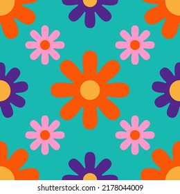Hippy flowers seamless pattern on a turquoise background. Bright floral background in 1970s flat cartoon style. Can be used as a wallpaper, wrapping paper, textile print etc.