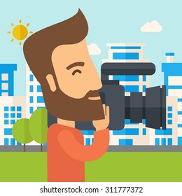 A hipster cameraman with video camera taking a video with thye buildings around. A Contemporary style with pastel palette, soft blue tinted background with desaturated clouds. Vector flat design